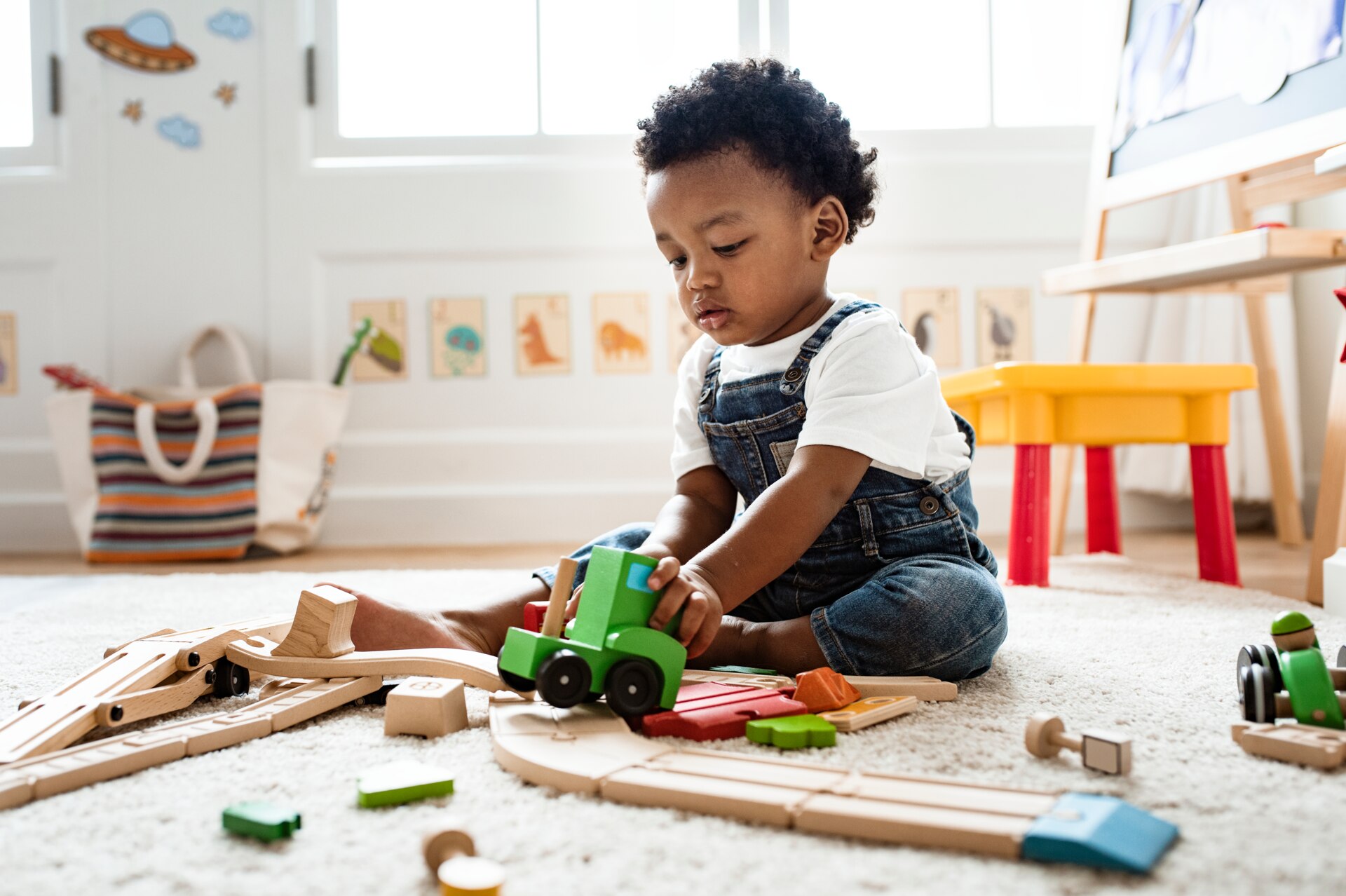 Little boy playing with a train